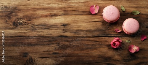 Pink macaroons adorned with rose petals on a wooden surface creating a charming and inviting lifestyle scene perfect for dessert promotions.