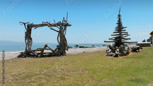 Driftwood art installations on a beach. Nature's sculptures by the sea. Coastal beauty. TE MATA, THAMES, COROMANDEL PENINSULA, NEW ZEALAND