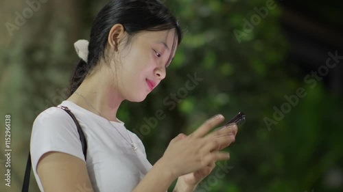 Woman using smartphone at night, Night lights, Bokeh of lights.