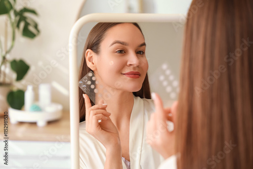Young woman with pimple pat...