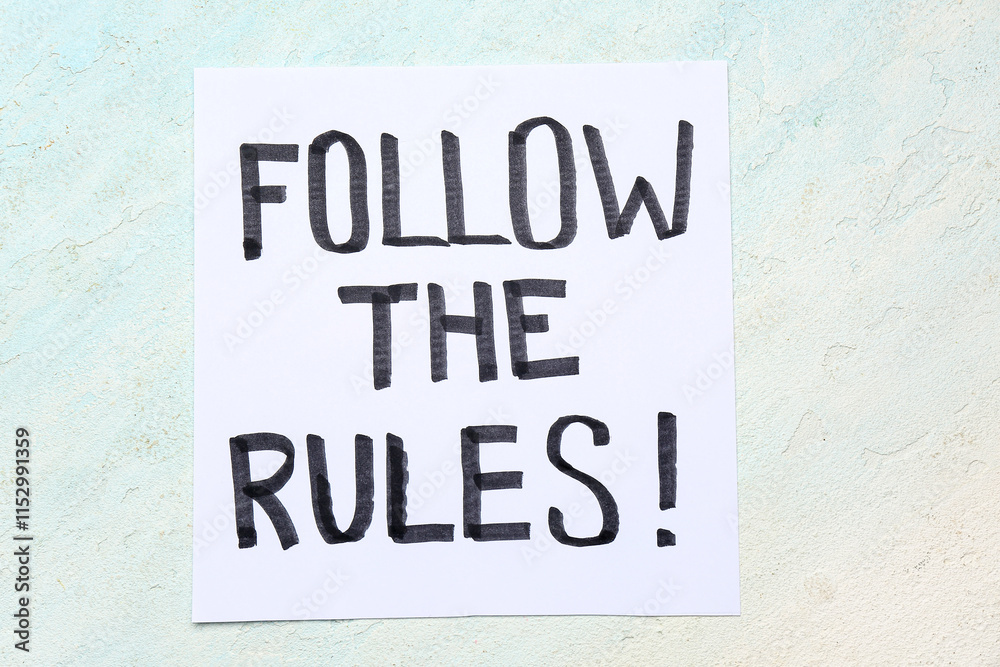 Paper with text KNOW THE RULES on light grunge background Paper with text KNOW THE RULES on light grunge background