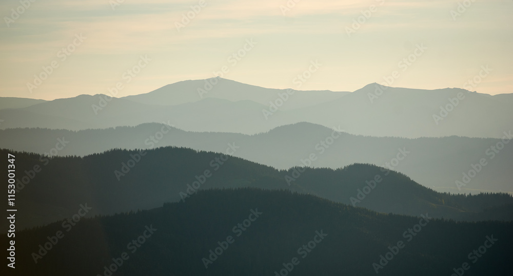 Mesmerizing view of layered mountain ranges in soft shades of green and gray, creating a sense of depth and tranquility under a subtle, misty sky. Mesmerizing view of layered mountain ranges in soft shades of green and gray, creating a sense of depth and tranquility under a subtle, misty sky.