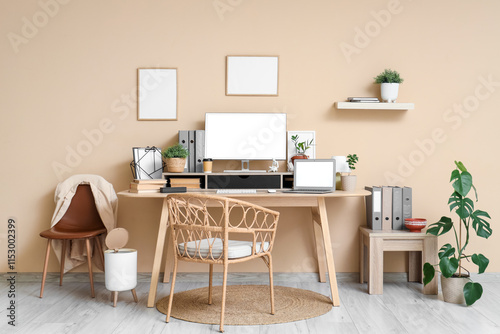 Modern home office workspace with blank computer monitor and laptop screen mi...