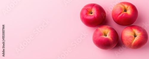 Four Ripe Peaches on Pink Background photo