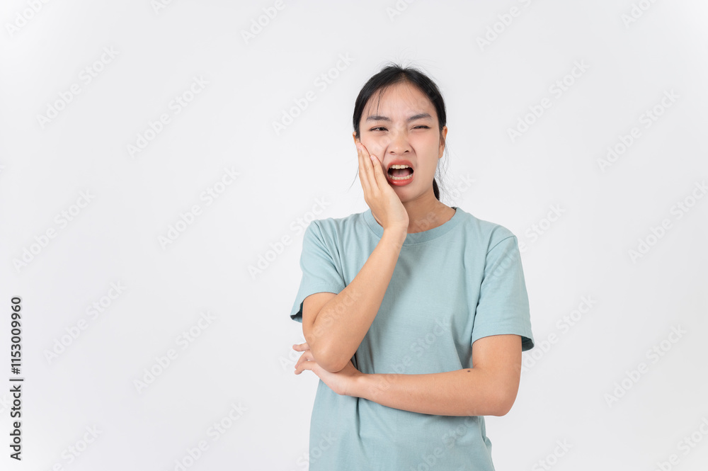 A sick, uncomfortable young Asian woman touching her cheek, suffering from a toothache. A sick, uncomfortable young Asian woman touching her cheek, suffering from a toothache.