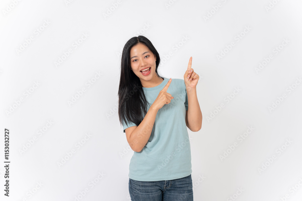 A beautiful Asian woman on a studio background, pointing her finger up as she recommend something. A beautiful Asian woman on a studio background, pointing her finger up as she recommend something.