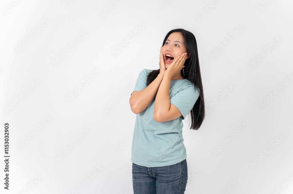 An excited Asian woman on a studio background with a surprising face expression. wow, amazed An excited Asian woman on a studio background with a surprising face expression. wow, amazed