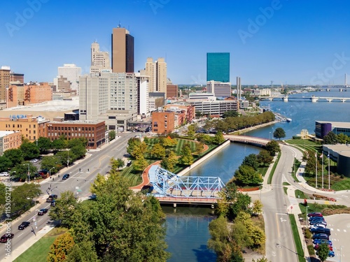 Aerial view of downtown city, showing modern buildings, a canal, and bridges. Urban landscape with traffic and parking. DOWNTOWN, TOLEDO, OHIO, UNITED STATES photo