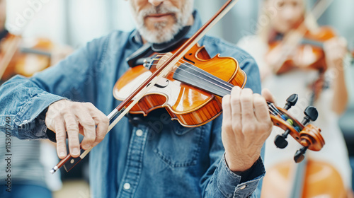 Close up professional Caucasian musician elderly man playing the violin with symphony orchestra classical music on violin. Talented violinist and classical music player solo performance photo