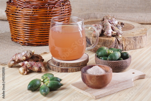 red ginger brewed drink photographed in a studio setting with traditional Indonesian theme props