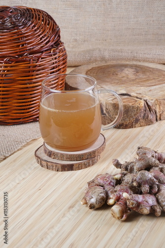 red ginger brewed drink photographed in a studio setting with traditional Indonesian theme props