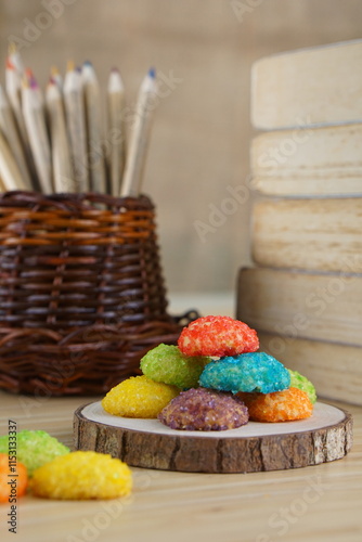 Indonesian colorful granulated sugar sprinkled biscuits photographed with a wooden theme in an indoor studio