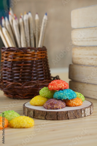 Indonesian colorful granulated sugar sprinkled biscuits photographed with a wooden theme in an indoor studio
