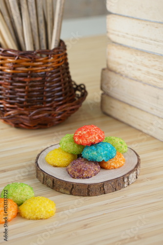 Indonesian colorful granulated sugar sprinkled biscuits photographed with a wooden theme in an indoor studio