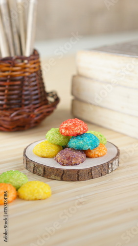 Indonesian colorful granulated sugar sprinkled biscuits photographed with a wooden theme in an indoor studio