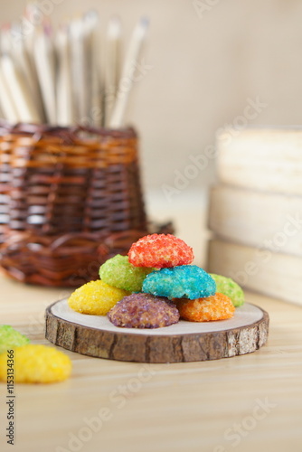 Indonesian colorful granulated sugar sprinkled biscuits photographed with a wooden theme in an indoor studio