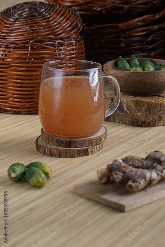 red ginger and areca nut brewed drink photographed in a studio setting with traditional Indonesian theme props