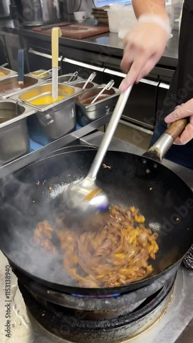 vertical video, wok cooking, making Thai stir fried noodles (pad see ew)