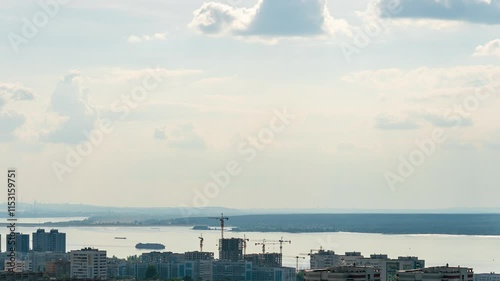 Naberezhnye Chelny, Russia. Clouds over the city. Nizhnekamsk Reservoir. Dam. Roofs of houses and construction of new houses, TimeLapse