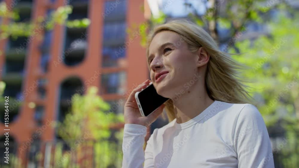 Young Woman Talking on Phone Outdoors in Urban Setting Young Woman Talking on Phone Outdoors in Urban Setting