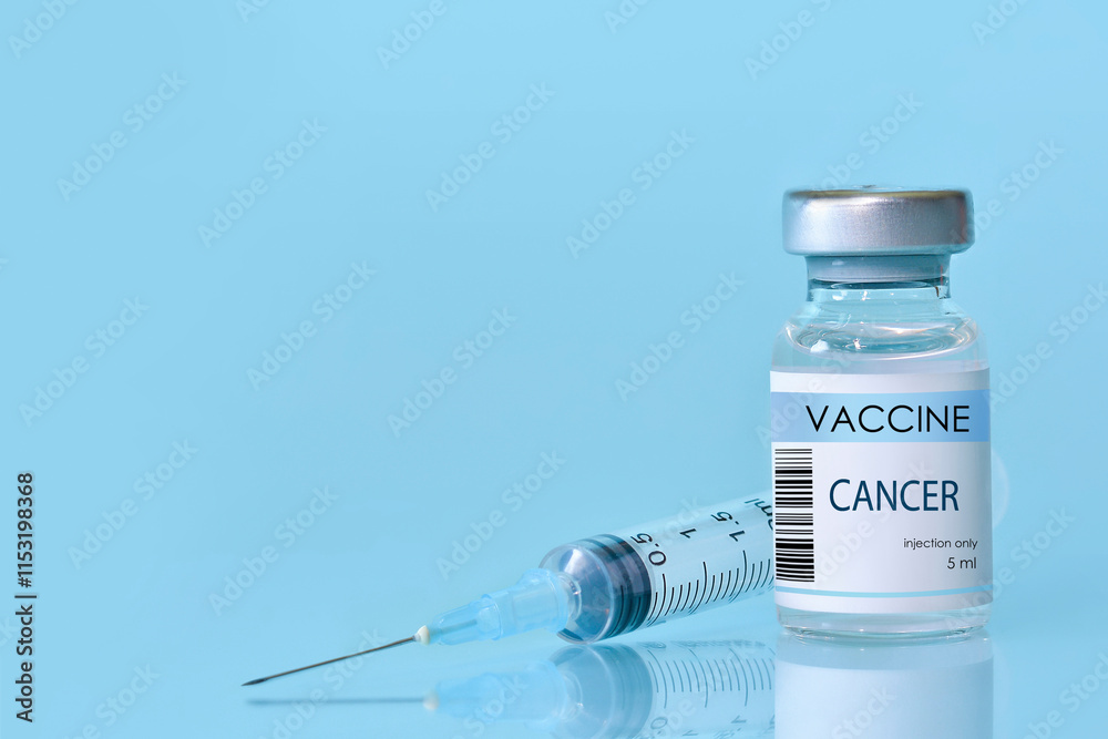 Cancer Vaccine in a bottle with a syringe on a blue background. Experimental cancer vaccine vial for immunization against Cancer disease.Copy space Cancer Vaccine in a bottle with a syringe on a blue background. Experimental cancer vaccine vial for immunization against Cancer disease.Copy space