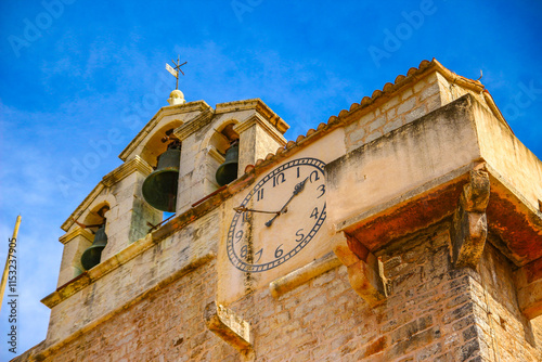 View of the monuments of Vrboska, attractions on the island of Hvar, moored boats in the bay photo