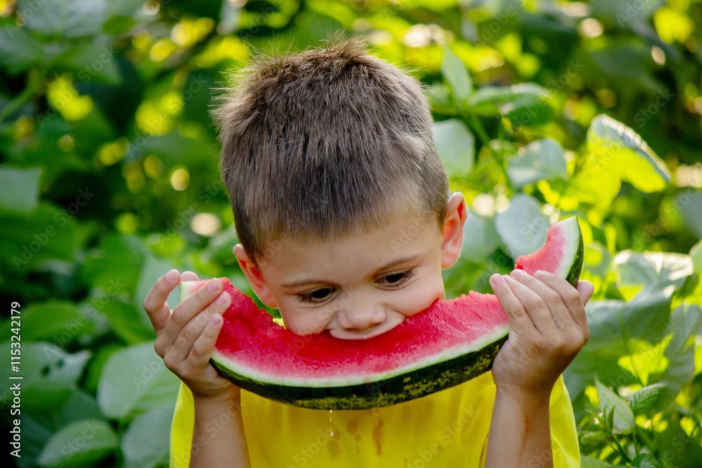 The child eats watermelon in the summer. Selective focus The child eats watermelon in the summer. Selective focus