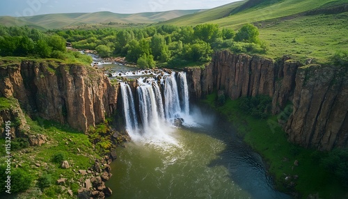 Bird eye view of the Ulaan Tsutgalan Waterfall, with water cascading into a rocky gorge surrounded by lush greenery, in 4K resolution photo