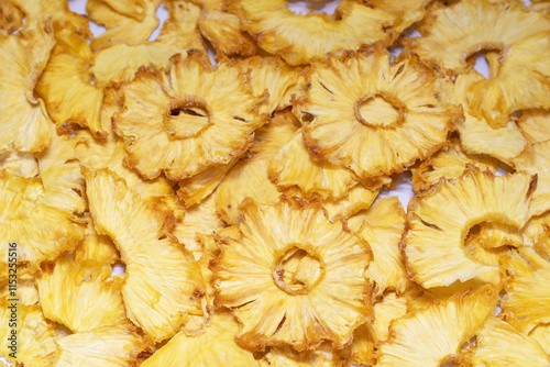 Close-up of dry pineapple rings. Fruity background, healthy food. Frips, chips, pineapple snacks, selective focus photo