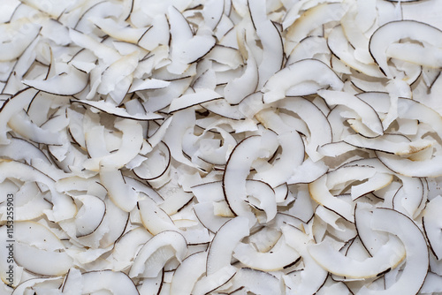 Dried coconut, coconut flakes, coconut chips background, coconut chips, healthy and proper food, selective focus, abstract background