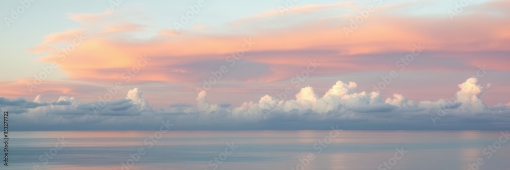 Obraz premium Serene Seascape with Soft Pastel Clouds Reflecting on Calm Water During Sunrise, Creating a Tranquil and Peaceful Atmosphere for Nature Lovers and Photographers