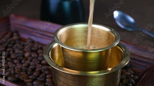 Serving Indian filter coffee in a cup.