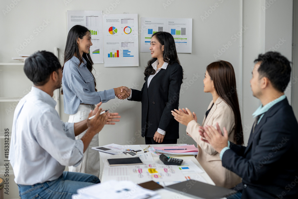 A group of people are shaking hands in a business setting A group of people are shaking hands in a business setting