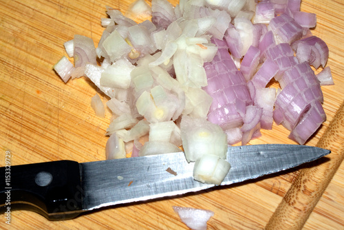 Chopped Onion On Wooden Board with a Knife photo