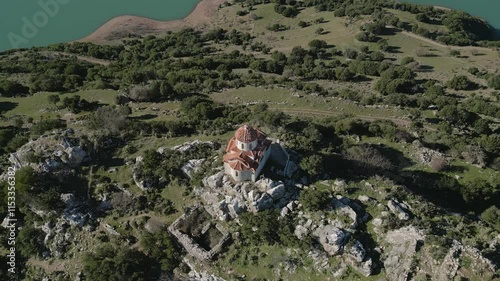 Unveiling the picturesque Mornos Lake nestled behind the chapel of St. George, a harmonious scene of nature and heritage photo