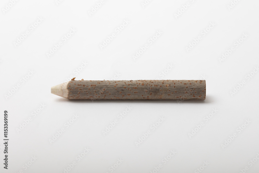 Close-up of a natural pencil made from a carved tree branch