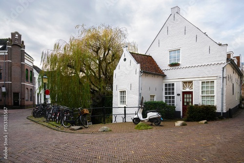 City street with a view of the facades of Amersfoort houses with a motorcycle and bicycles in Amersfoort
