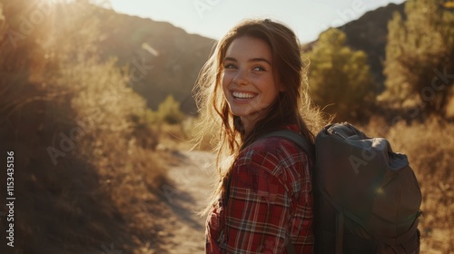 Happy young woman hiking on a scenic trail during sunset
