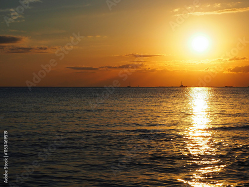 Warm afterglow of sunset at the horizon. from the beach of Gallipoli, Apulia, Italy.