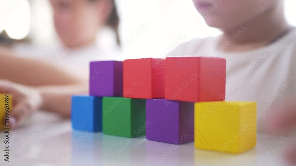 A group of children are building together blocks. Play cubes table concept. Group of children in kindergarten with cubes. Children in groups kindergarten building blocks together in a. lifestyle. A group of children are building together blocks. Play cubes table concept. Group of children in kindergarten with cubes. Children in groups kindergarten building blocks together in a. lifestyle.
