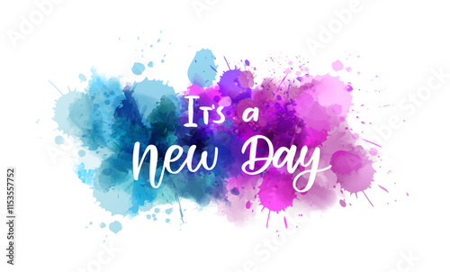 It's a new day - handwritten modern calligraphy inspirational text on multicolored watercolor paint splash.