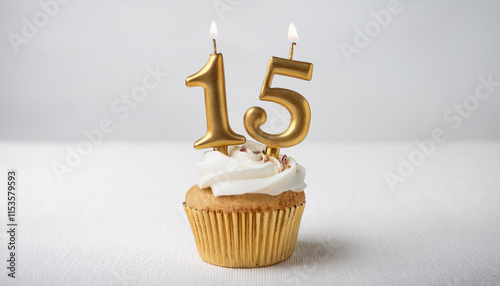 Cupcake with white cream and burning golden candle number 15. Tasty festive food. Delicious dessert. photo