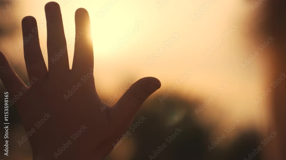 silhouette of hand of girl child in sun glare. faith in god religion concept. close up hand child girl fingers silhouette at sunset sun glare lifestyle in nature. dreams religion future concept silhouette of hand of girl child in sun glare. faith in god religion concept. close up hand child girl fingers silhouette at sunset sun glare lifestyle in nature. dreams religion future concept