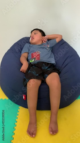 Children who use NGT (nasogastric tube) or sonde are experiencing seizure disorders while sitting on a blue bean-shaped sofa