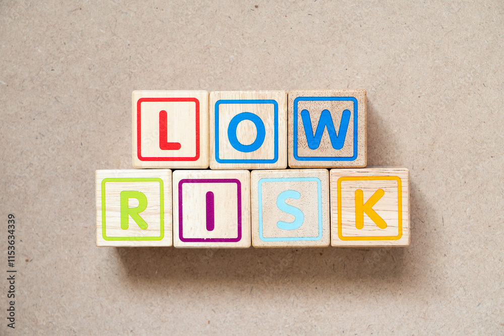Alphabet letter block in word low risk on wood background Alphabet letter block in word low risk on wood background