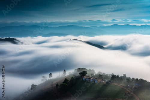 Φωτογραφία Landscape of sea of fog flowing over mountain with homestay on hill in countrysi