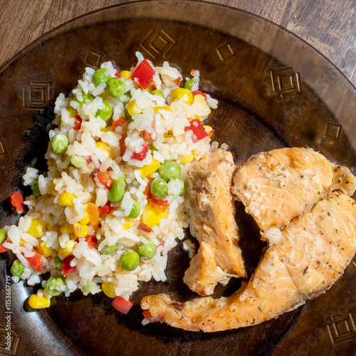 rice, vegetables and fish on dark plate