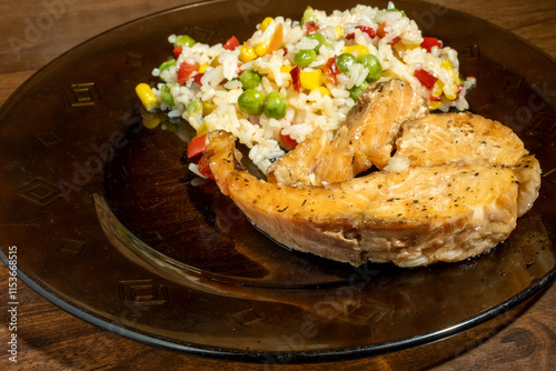 rice, vegetables and fish on dark plate