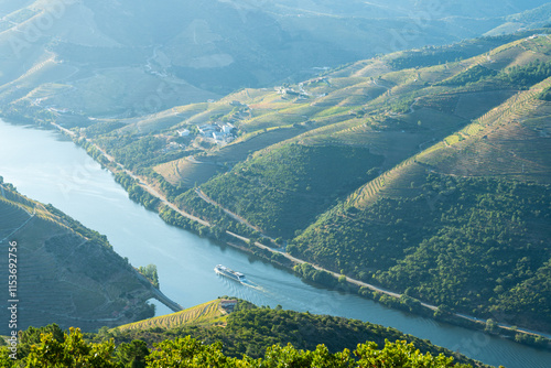 Douro Valley and Douro River with Boat on Sunny Hazy Morning. Green Hills and Mountains. Portugal.
