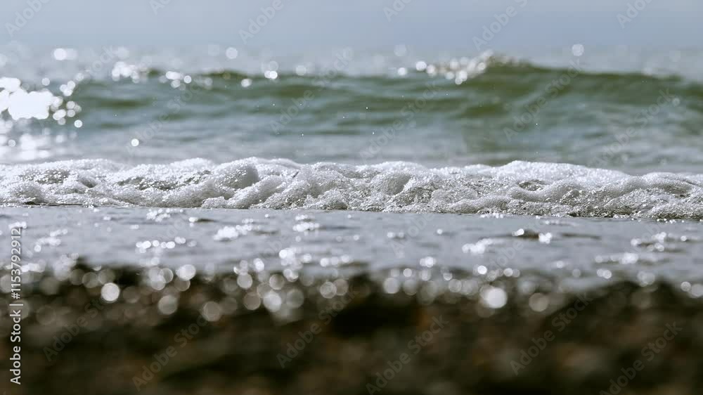 Gentle waves lapping shore at tranquil beachfront Gentle waves lapping shore at tranquil beachfront